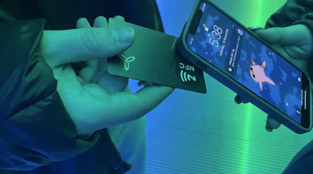 Close-up of an NFC card touching a phone as the tag notification appears